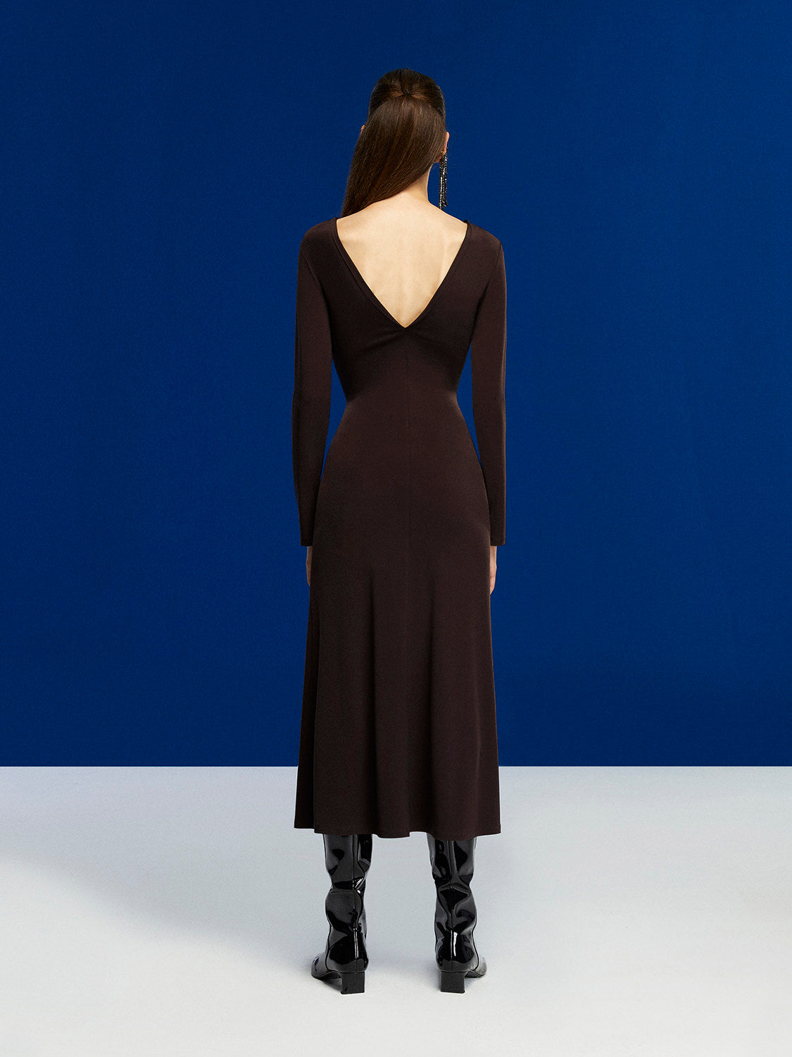 A stylish Deep V-Neck Midi Dress in Neo Brown with long sleeves, open back, and flounced hem, perfect for winter occasions.