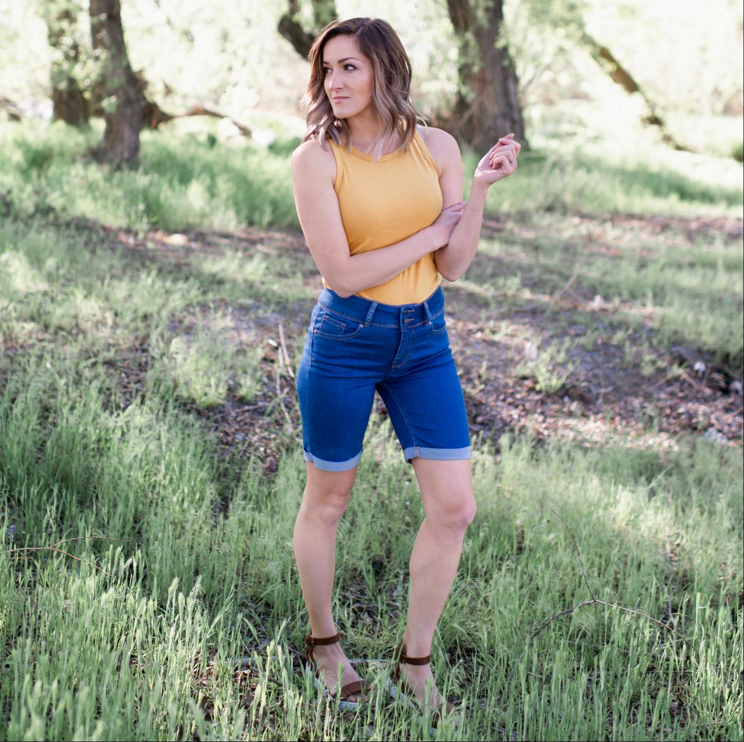 A pair of distressed Destroyed Bermuda Shorts showcasing a casual style, featuring belt loops and a soft fabric blend, perfect for summer wear.