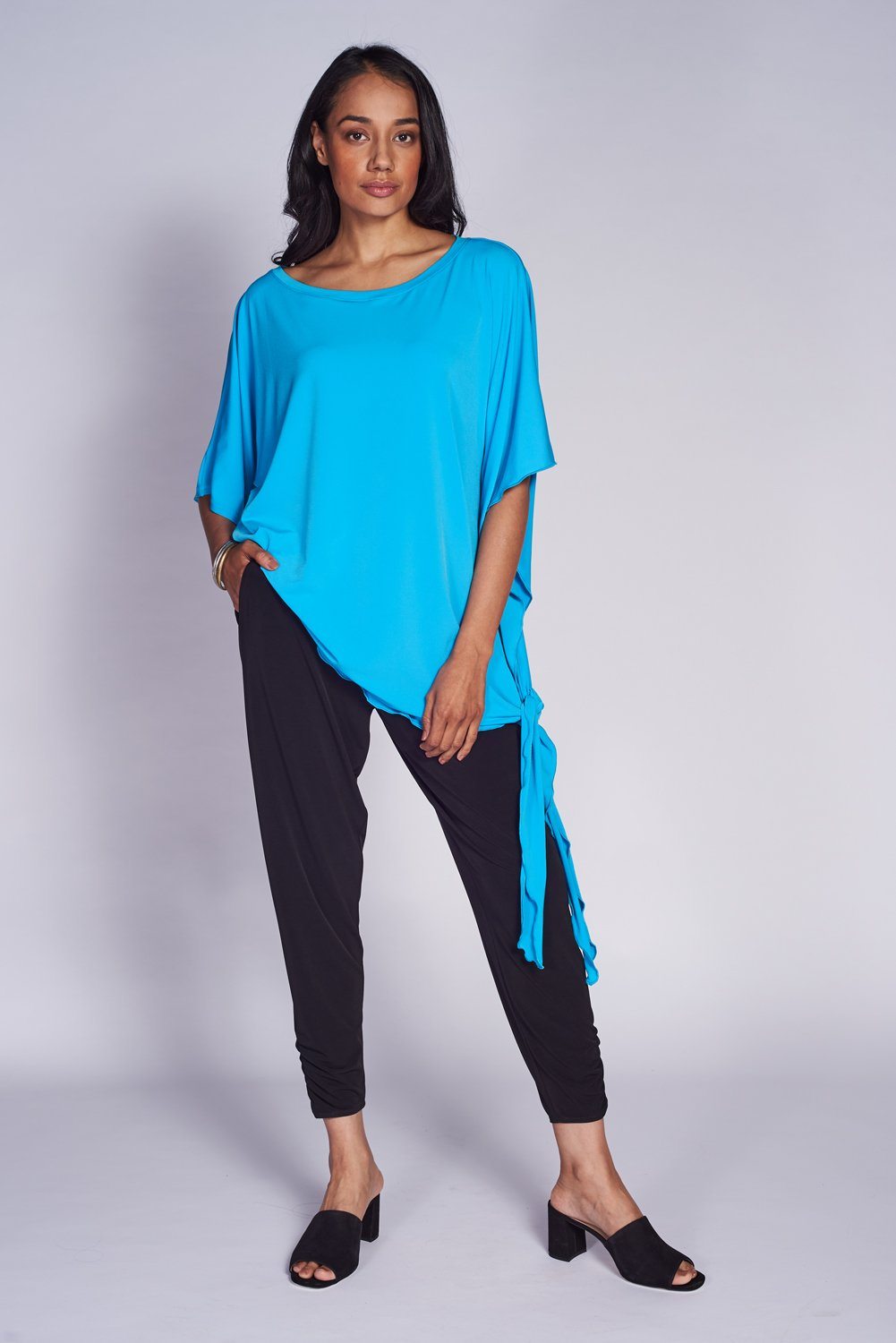 A stylish Dolman Side Tie Tunic in a versatile color, featuring a side tie for adjustable fit and wide sleeves for comfort.