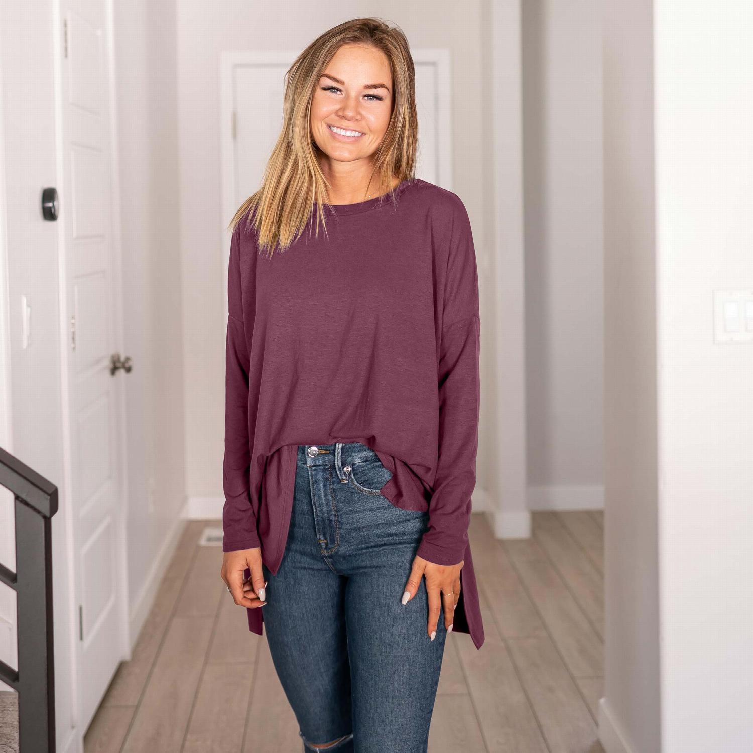 A stylish Dolman Sleeve Round Neck Top with a hi-low hem and side slits, showcasing its relaxed fit and unique silhouette.