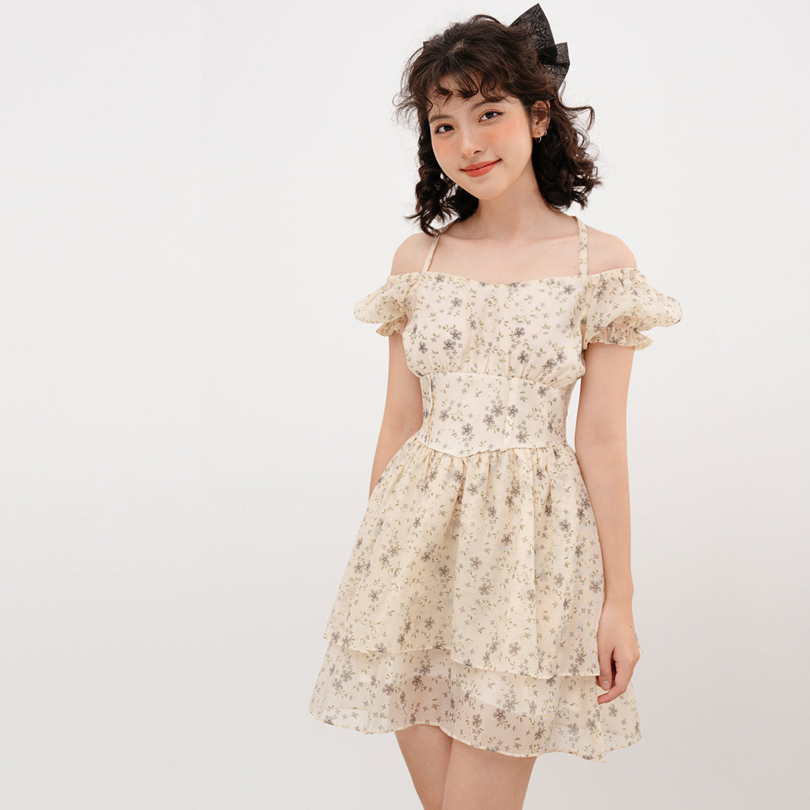 Doris Dress featuring beige silk fabric with baby flower prints and ruffled skirt design.