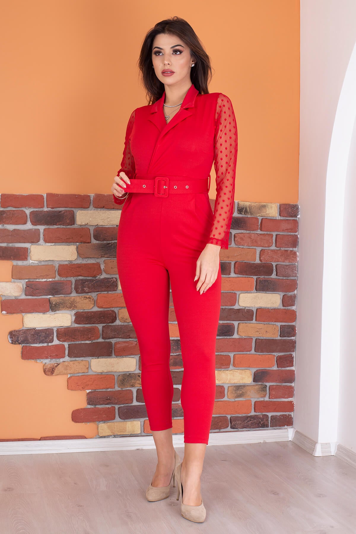 Elegant double-breasted jumpsuit with a belted waist, showcasing a stylish design suitable for various occasions.