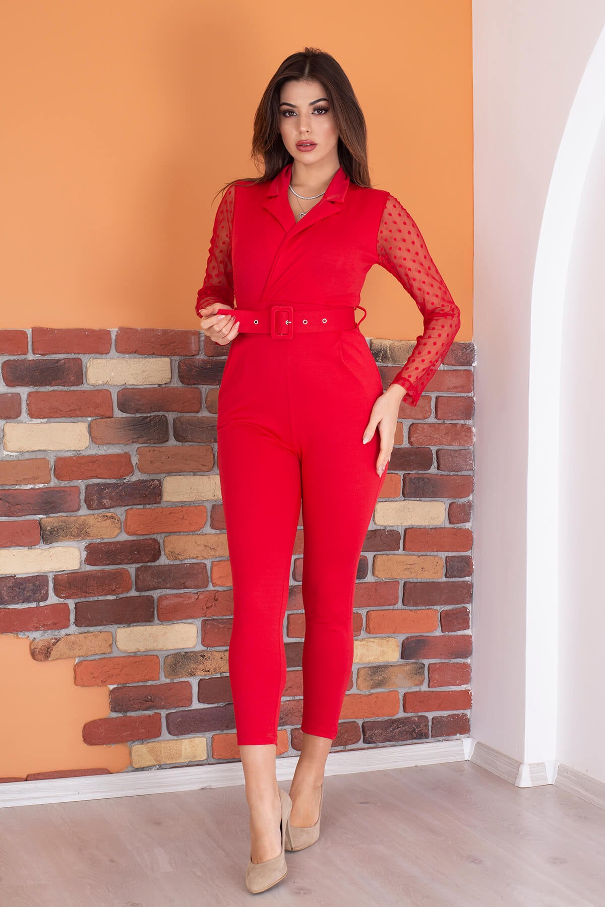 Elegant double-breasted jumpsuit with a belted waist, showcasing a stylish design suitable for various occasions.