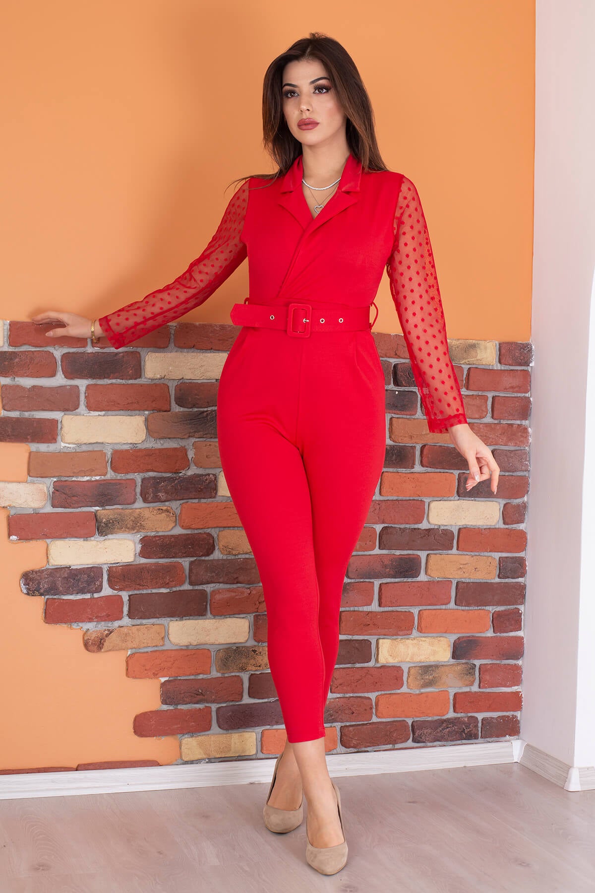 Elegant double-breasted jumpsuit with a belted waist, showcasing a stylish design suitable for various occasions.