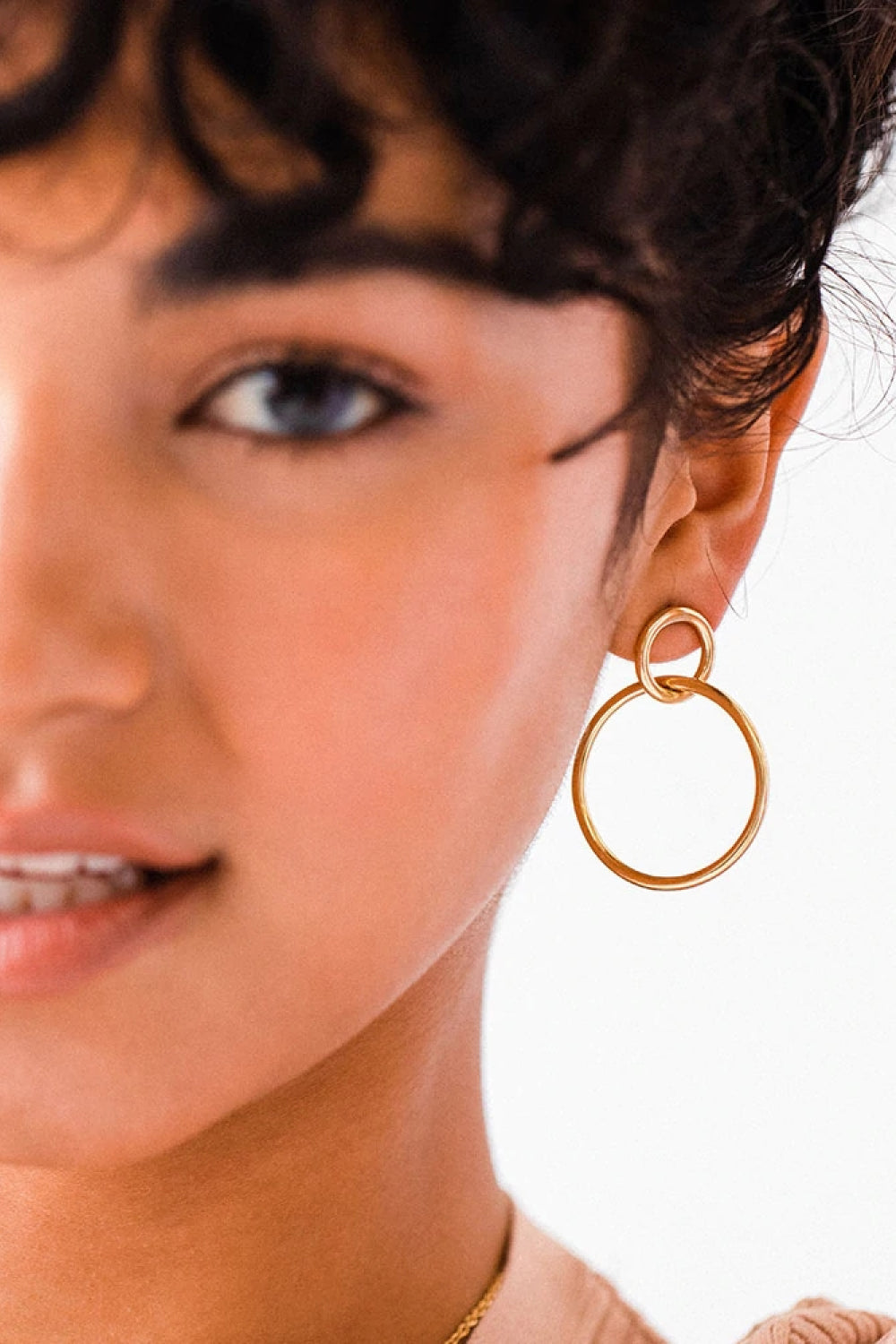 Elegant Double Hoop Drop Earrings in gold-plated stainless steel, showcasing their unique design and lightweight structure.