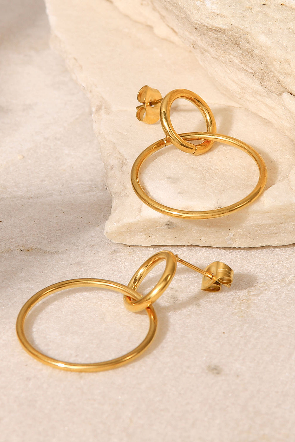 Elegant Double Hoop Drop Earrings in gold-plated stainless steel, showcasing their unique design and lightweight structure.