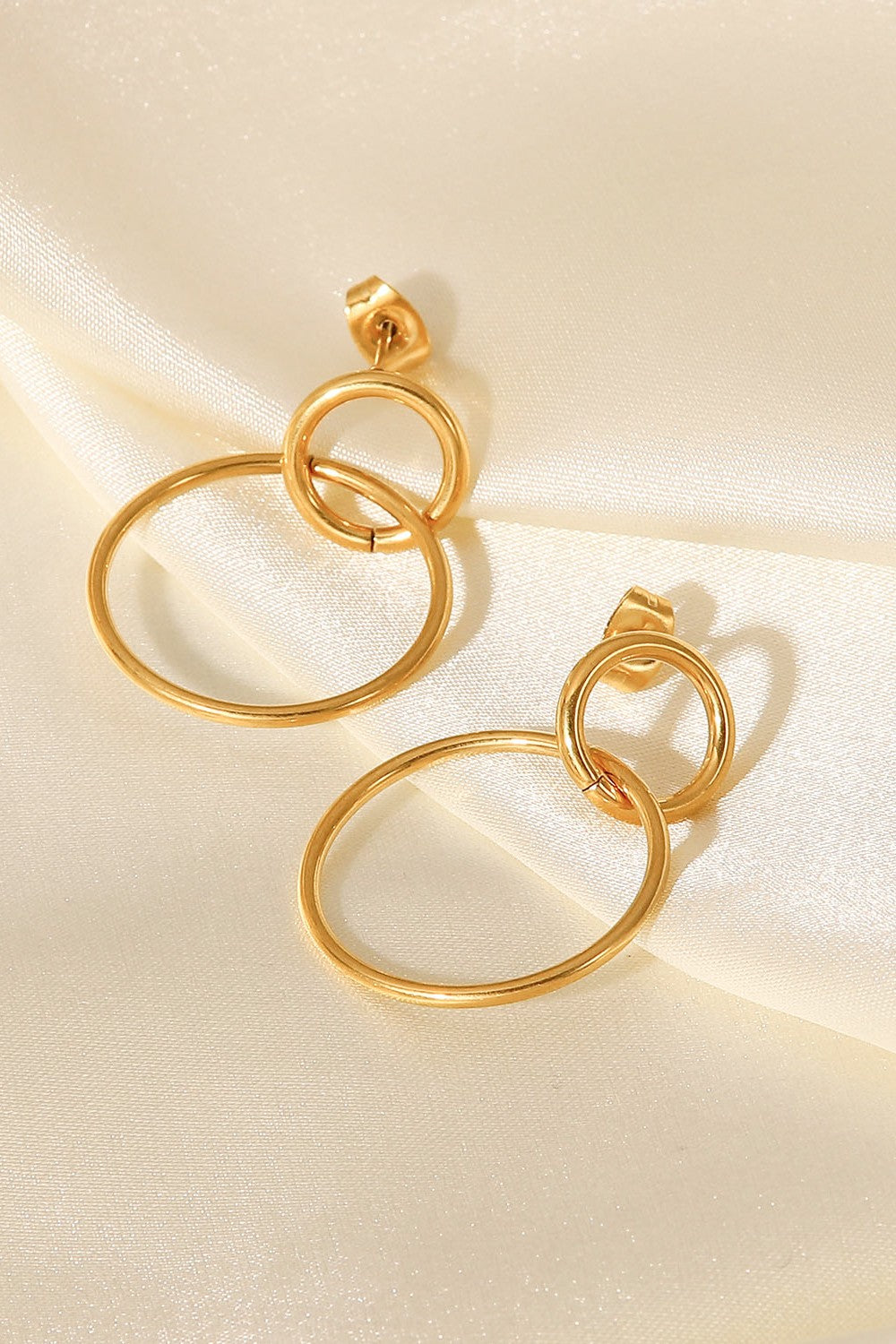 Elegant Double Hoop Drop Earrings in gold-plated stainless steel, showcasing their unique design and lightweight structure.