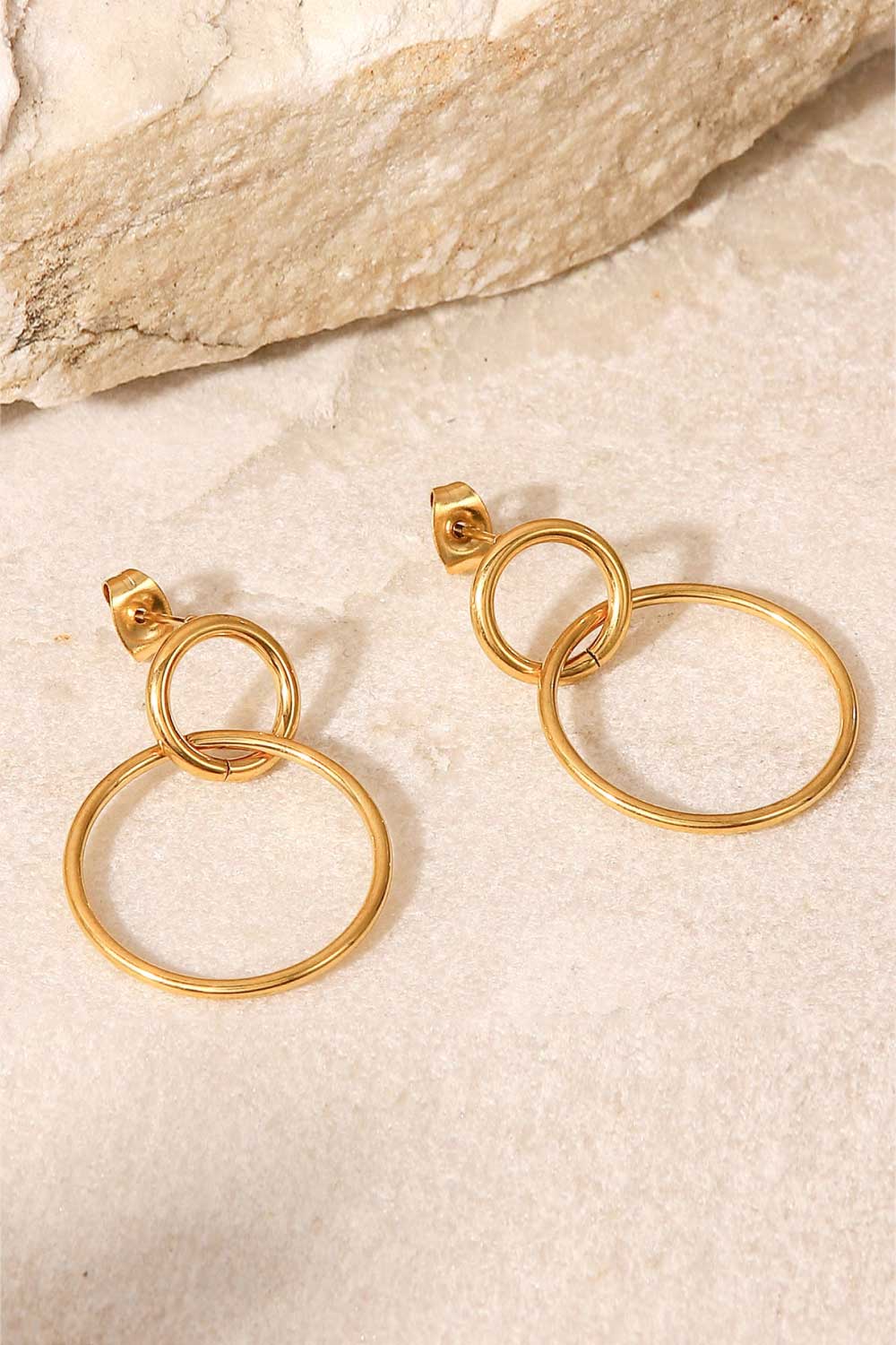 Elegant Double Hoop Drop Earrings in gold-plated stainless steel, showcasing their unique design and lightweight structure.