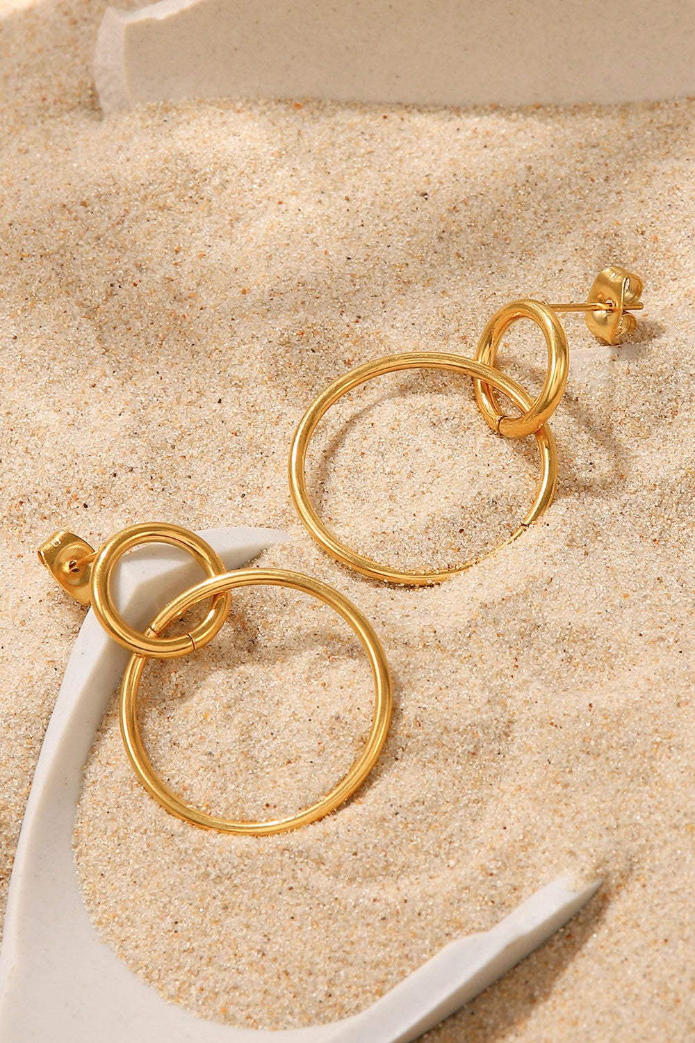 Elegant Double Hoop Drop Earrings in gold-plated stainless steel, showcasing their unique design and lightweight structure.