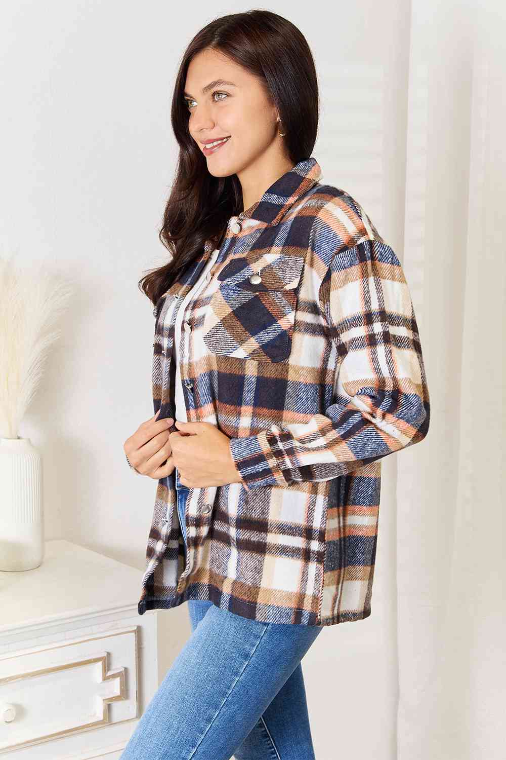 Double Take Plaid Button Front Shirt Jacket featuring breast pockets and long sleeves, styled for a casual look.