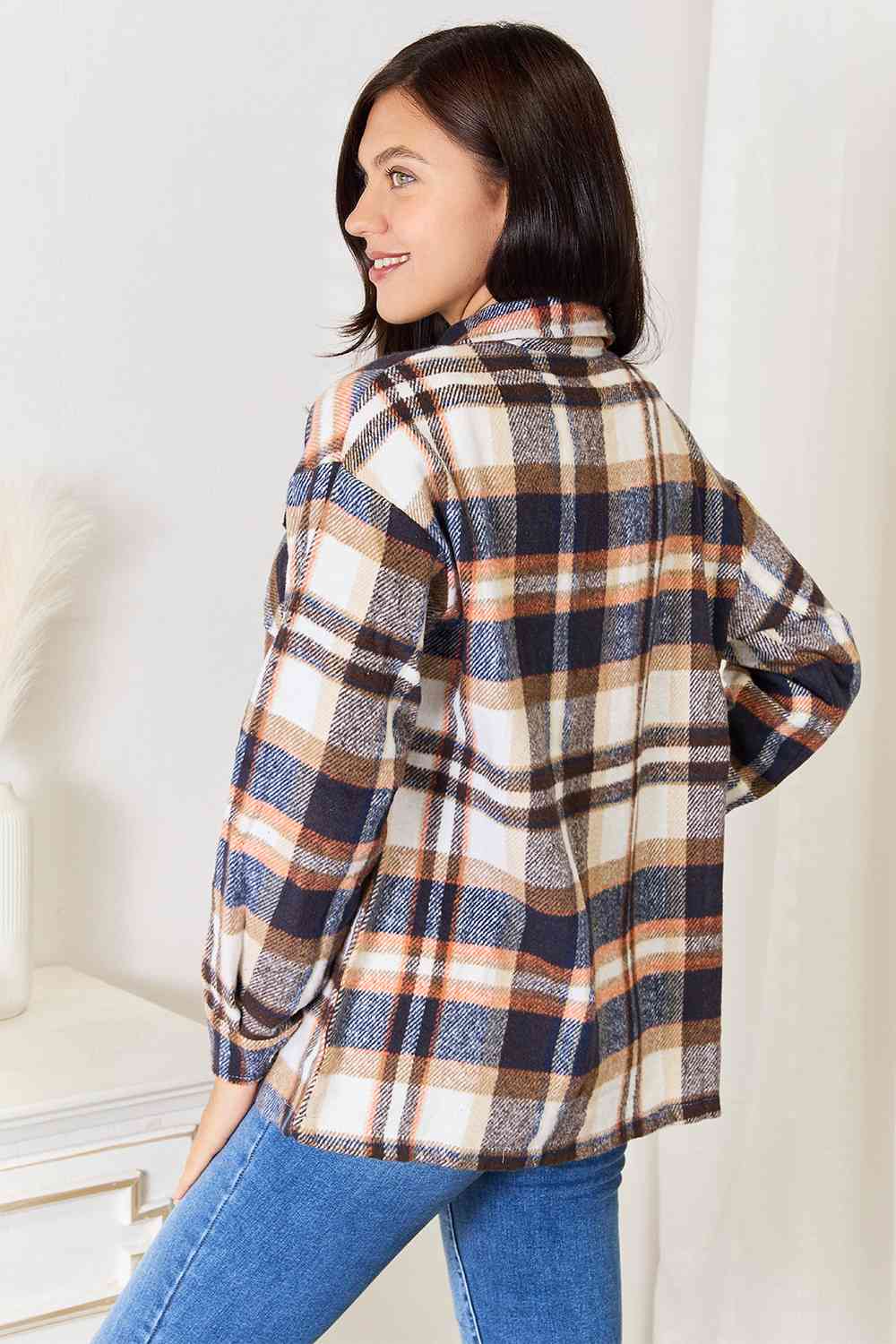 Double Take Plaid Button Front Shirt Jacket featuring breast pockets and long sleeves, styled for a casual look.