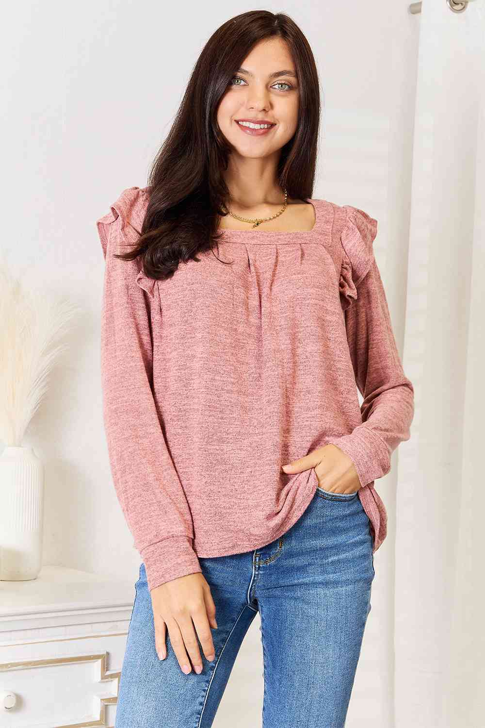 A stylish woman wearing a Double Take Square Neck Ruffle Shoulder Long Sleeve T-Shirt, showcasing its elegant square neckline and ruffle shoulder details.