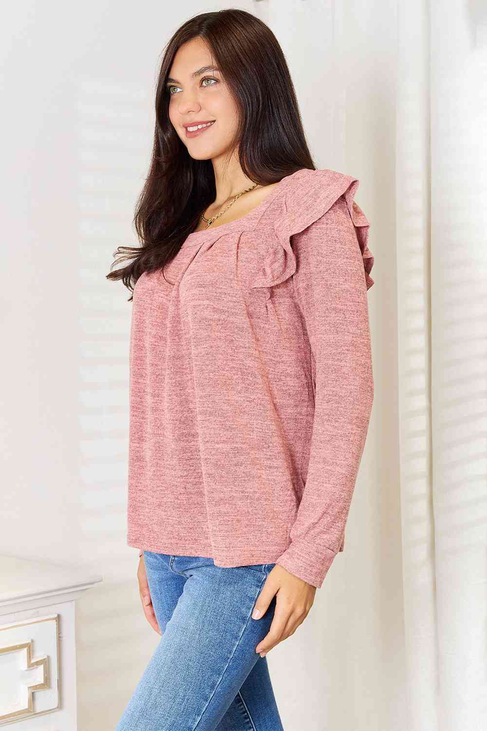 A stylish woman wearing a Double Take Square Neck Ruffle Shoulder Long Sleeve T-Shirt, showcasing its elegant square neckline and ruffle shoulder details.