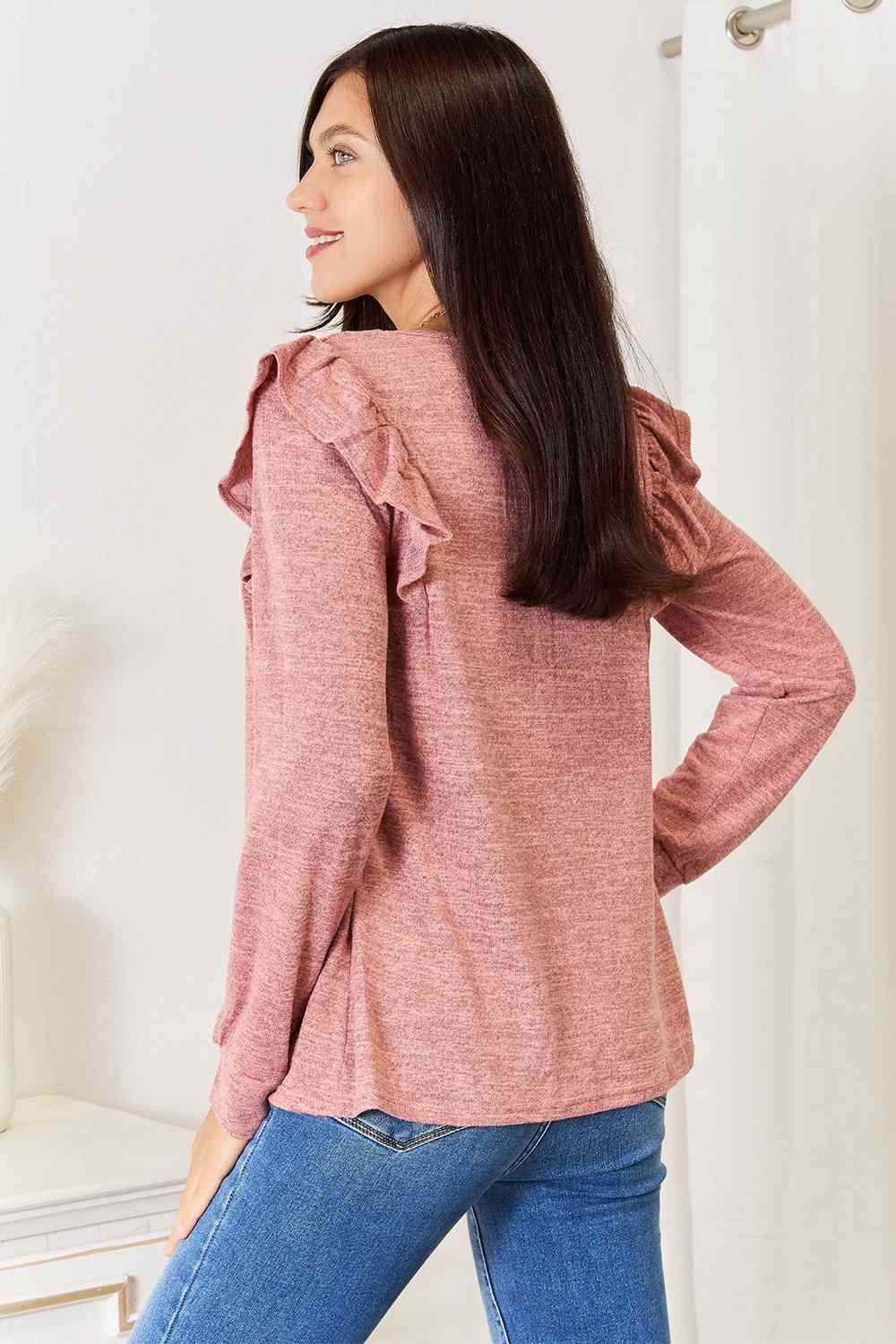 A stylish woman wearing a Double Take Square Neck Ruffle Shoulder Long Sleeve T-Shirt, showcasing its elegant square neckline and ruffle shoulder details.