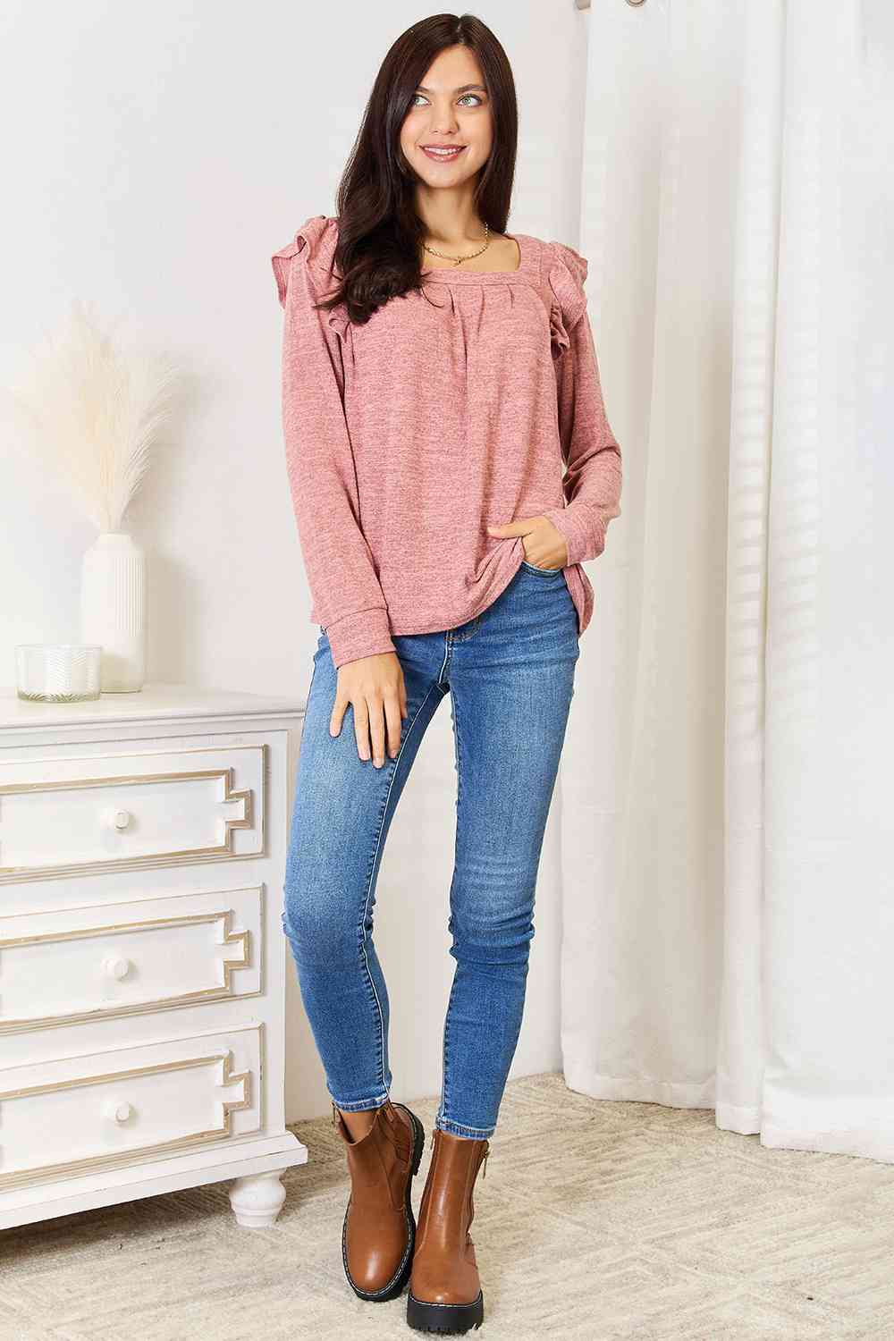 A stylish woman wearing a Double Take Square Neck Ruffle Shoulder Long Sleeve T-Shirt, showcasing its elegant square neckline and ruffle shoulder details.