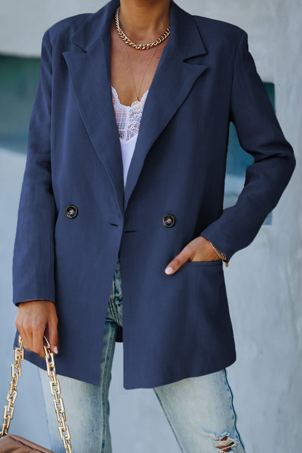 Double-breasted padded shoulder blazer with pockets, featuring a solid pattern and lapel collar, perfect for stylish layering.