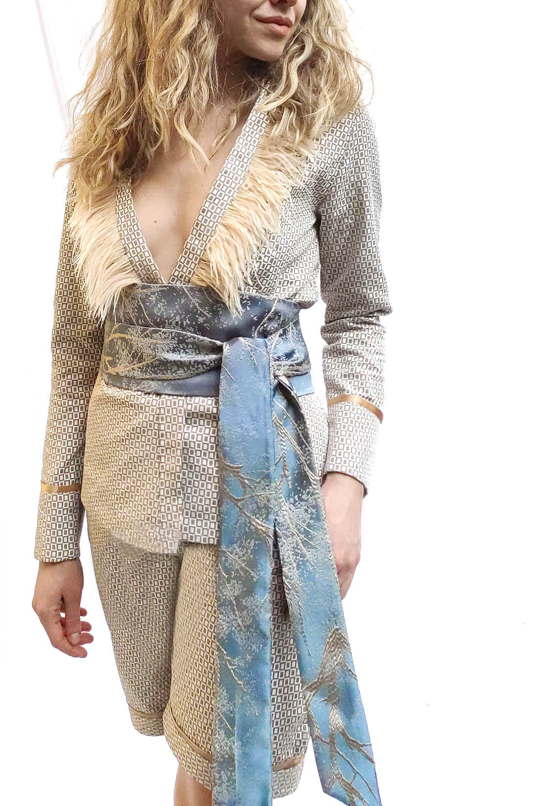 Dove Suit featuring cotton-linen fabric with geometric pattern and feathered collar, styled with matching waistband.