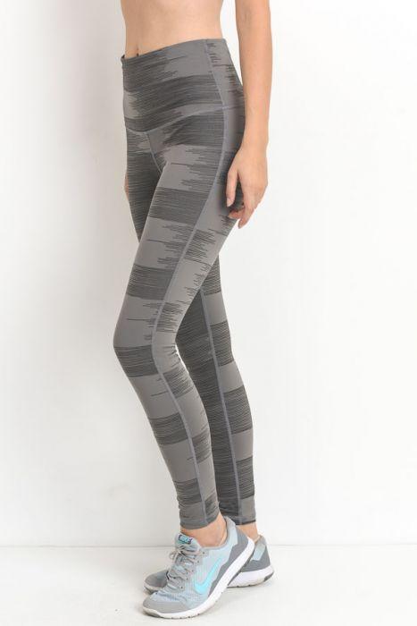 A pair of highwaist leggings featuring a drawn lines print in grey on a lighter grey background, showcasing a stylish and chic design.