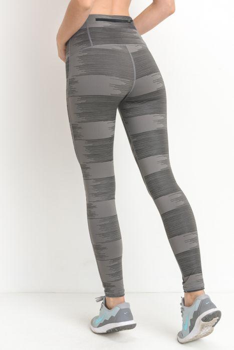 A pair of highwaist leggings featuring a drawn lines print in grey on a lighter grey background, showcasing a stylish and chic design.