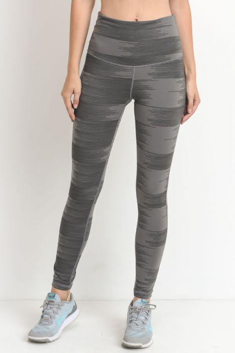 A pair of highwaist leggings featuring a drawn lines print in grey on a lighter grey background, showcasing a stylish and chic design.