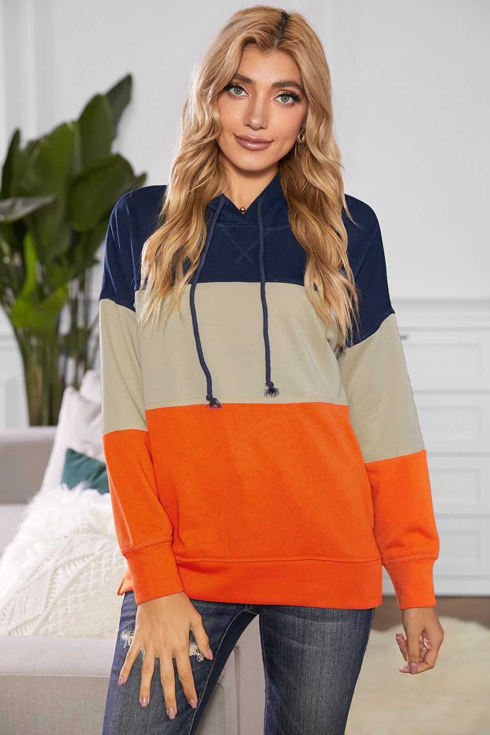 A stylish drawstring hoodie featuring a color block design with pastel stripes, perfect for casual wear.