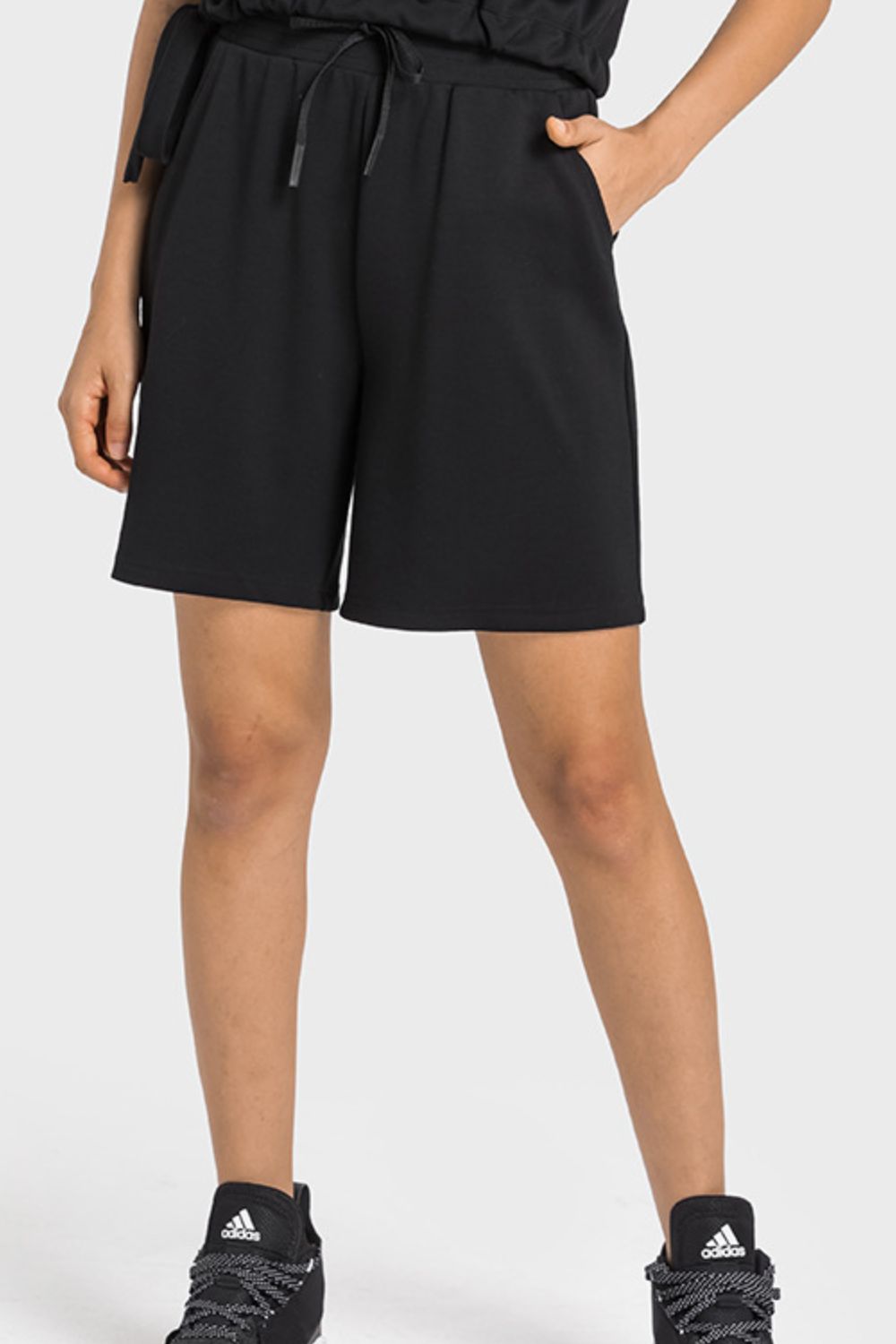 A pair of Drawstring Elastic Waist Sports Bermuda Shorts in solid color, showcasing the elastic waistband and soft fabric.