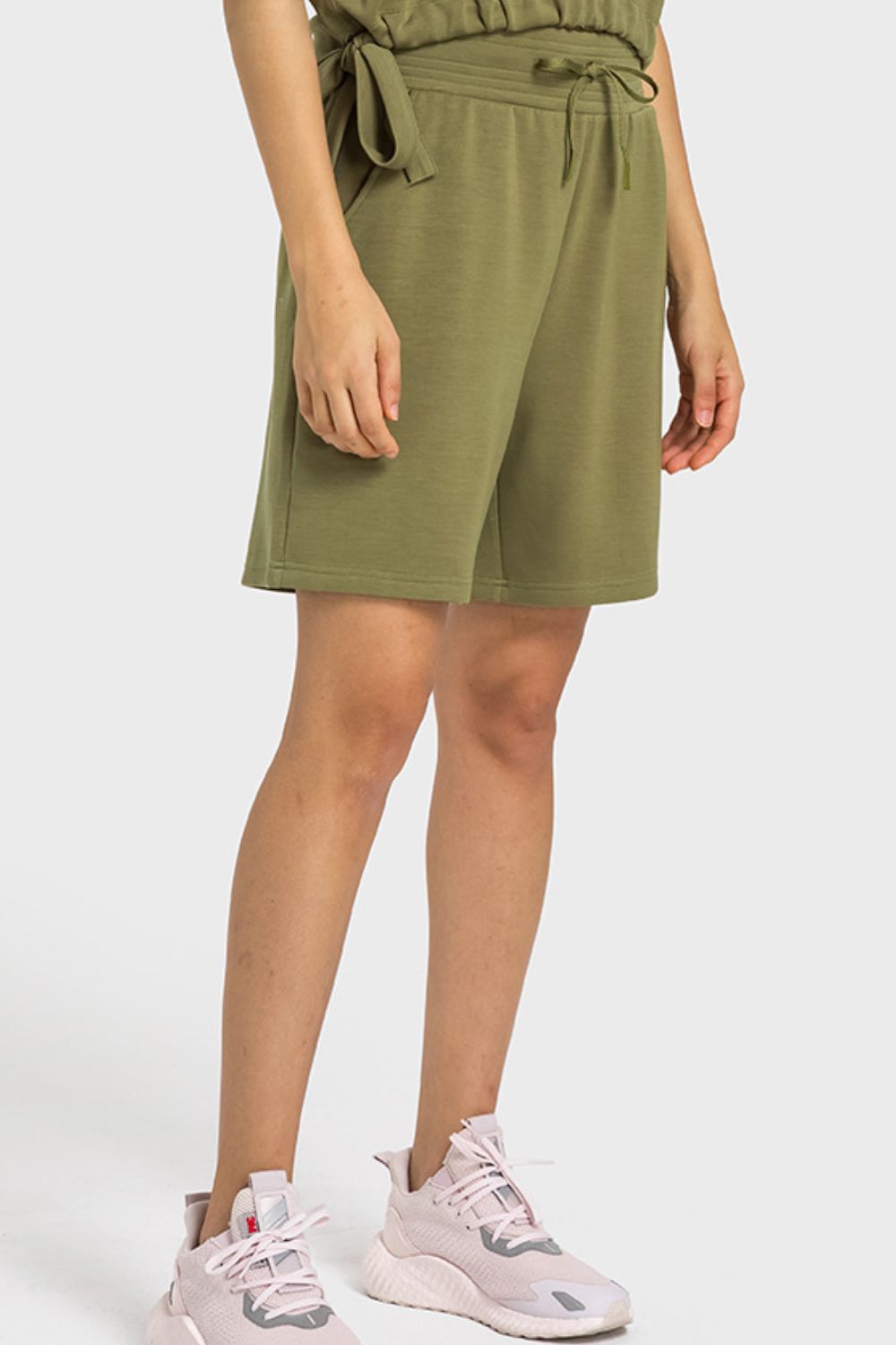 A pair of Drawstring Elastic Waist Sports Bermuda Shorts in solid color, showcasing the elastic waistband and soft fabric.