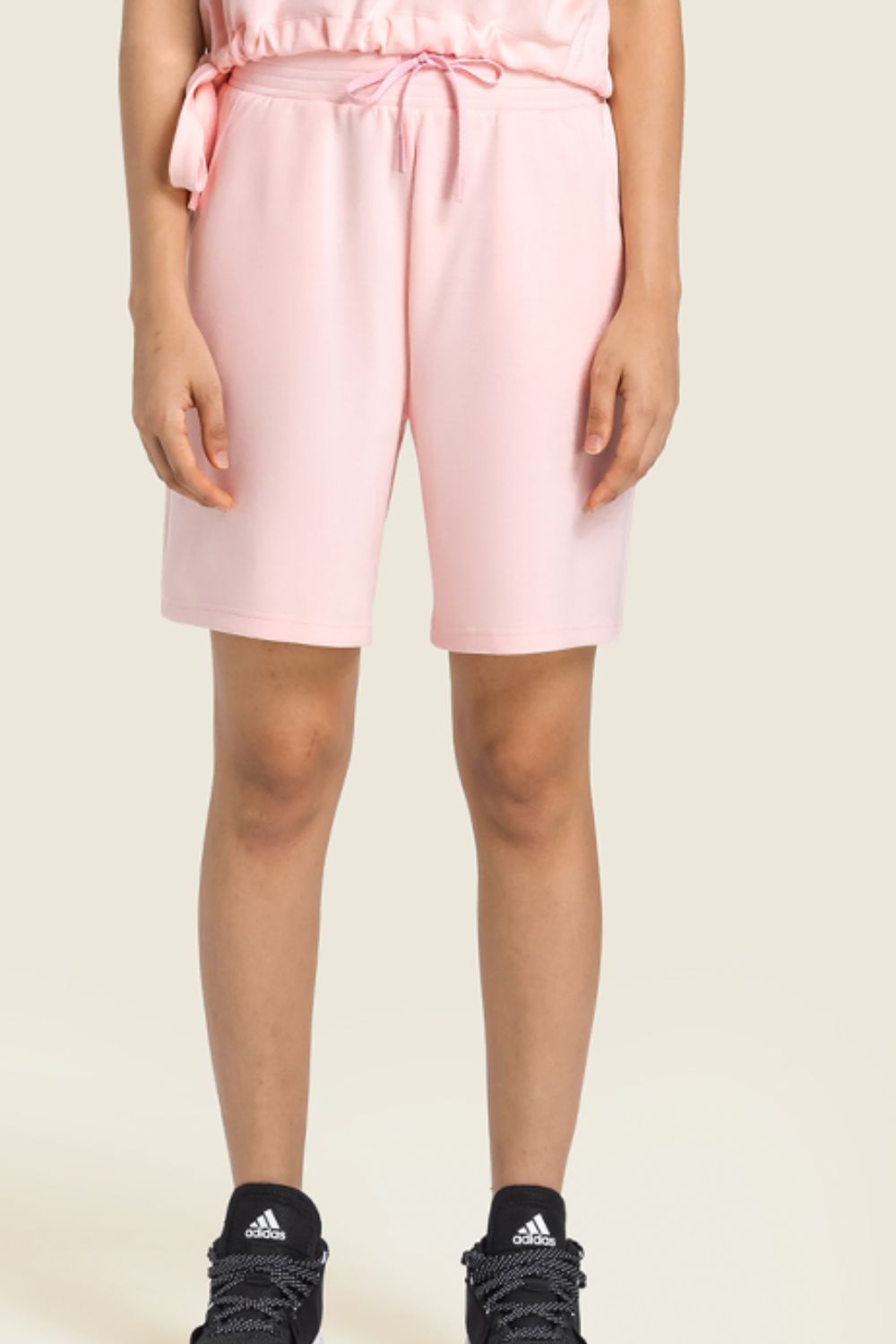 A pair of Drawstring Elastic Waist Sports Bermuda Shorts in solid color, showcasing the elastic waistband and soft fabric.