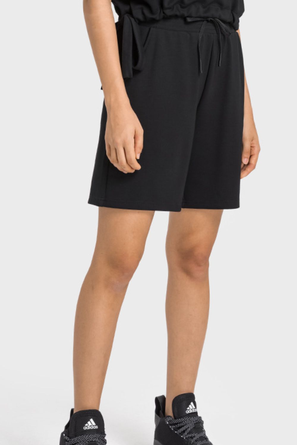 A pair of Drawstring Elastic Waist Sports Bermuda Shorts in solid color, showcasing the elastic waistband and soft fabric.