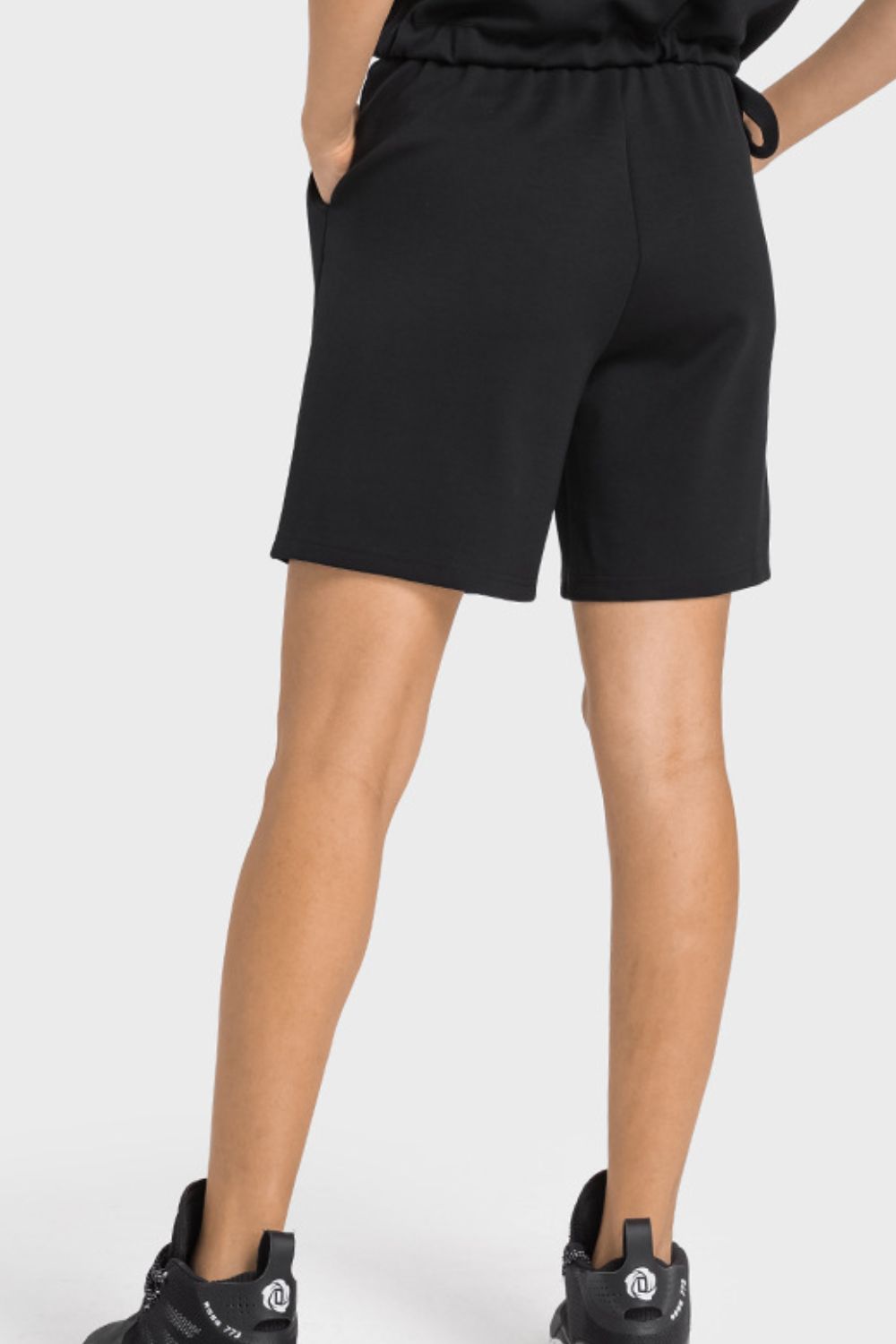 A pair of Drawstring Elastic Waist Sports Bermuda Shorts in solid color, showcasing the elastic waistband and soft fabric.