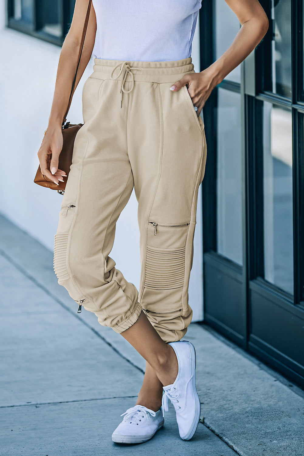 A pair of stylish drawstring joggers featuring zipper details and pockets, made from a soft stretchy fabric, perfect for casual wear.