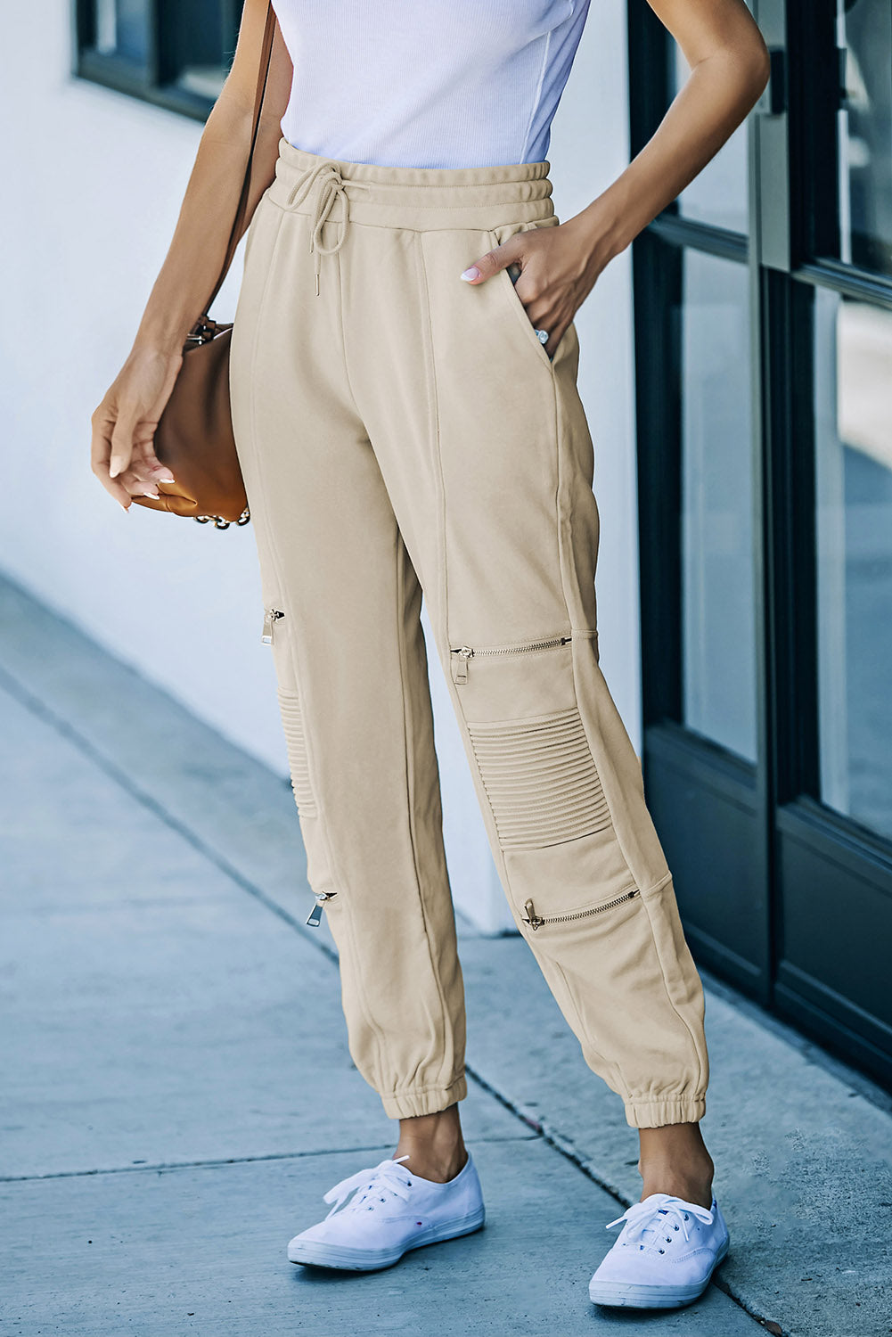 A pair of stylish drawstring joggers featuring zipper details and pockets, made from a soft stretchy fabric, perfect for casual wear.