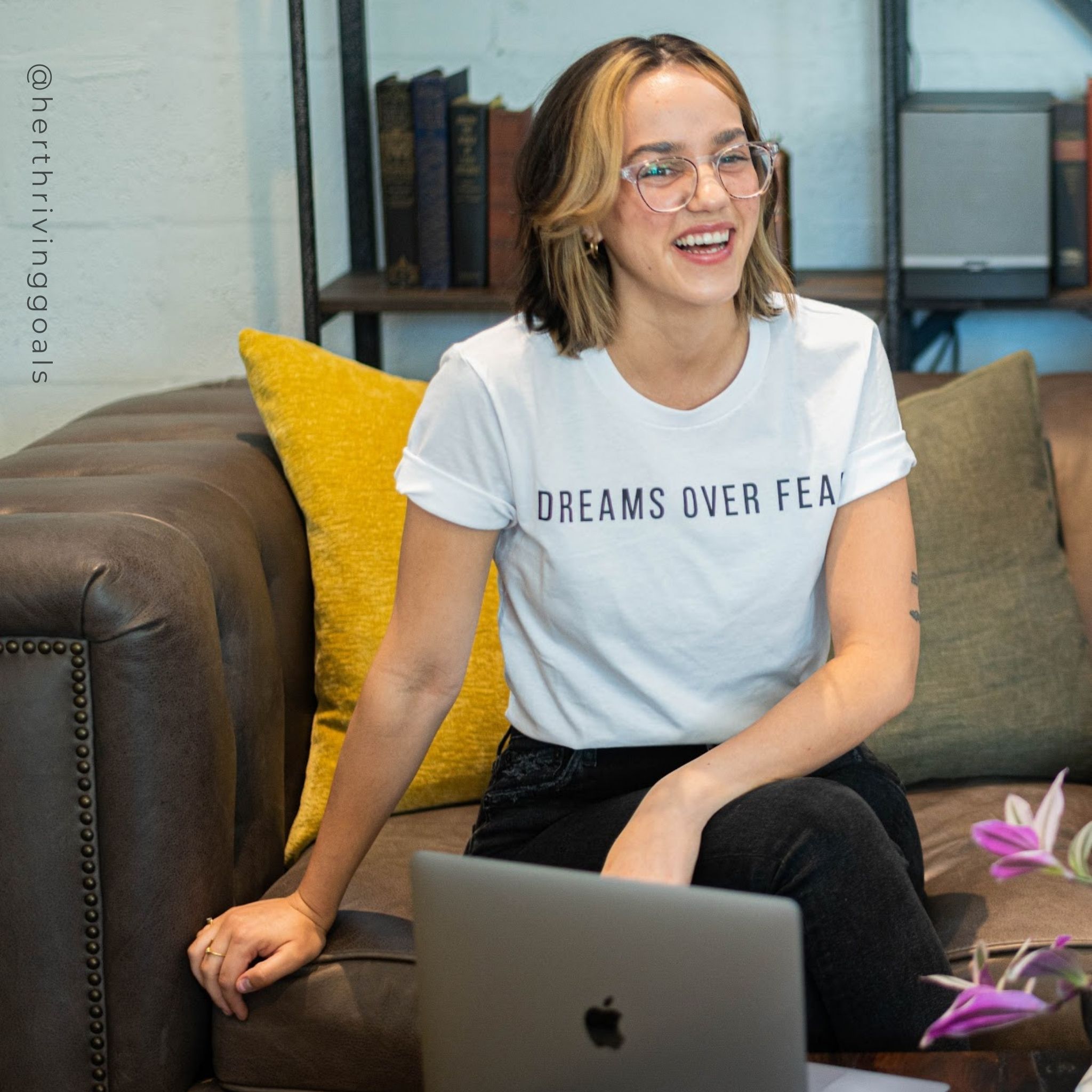 A woman wearing the Dreams Over Fear Tee, showcasing its inspirational message and comfortable fit.