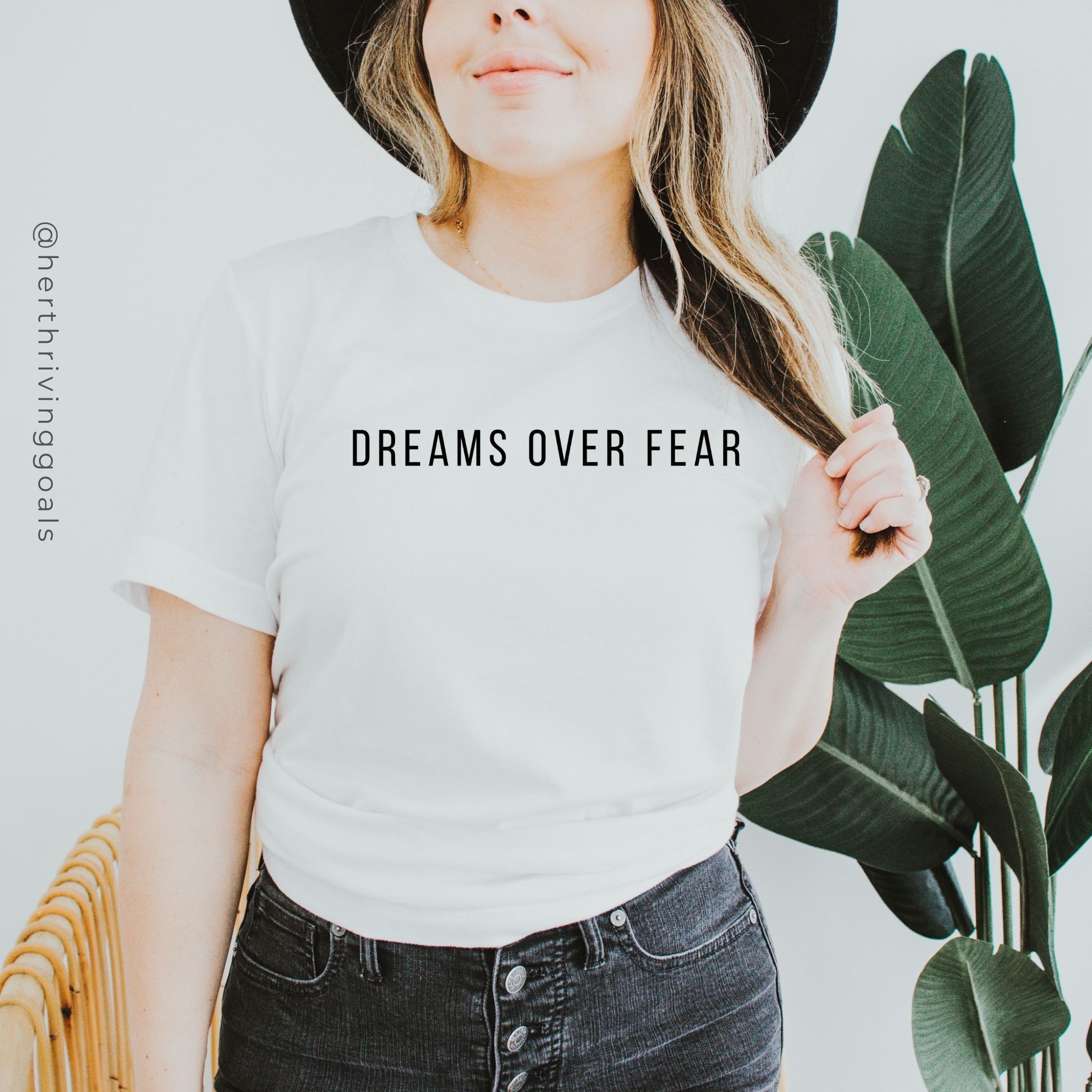 A woman wearing the Dreams Over Fear Tee, showcasing its inspirational message and comfortable fit.