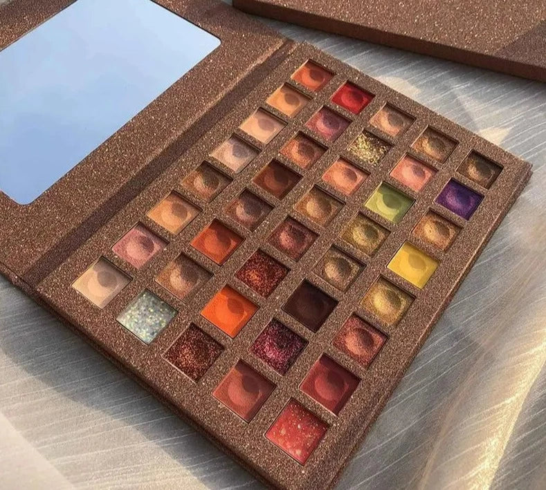 Dreamy 40 Color Eyeshadow Palette showcasing vibrant shades and glitter sequin eyeshadows in a sleek design with a mirror.