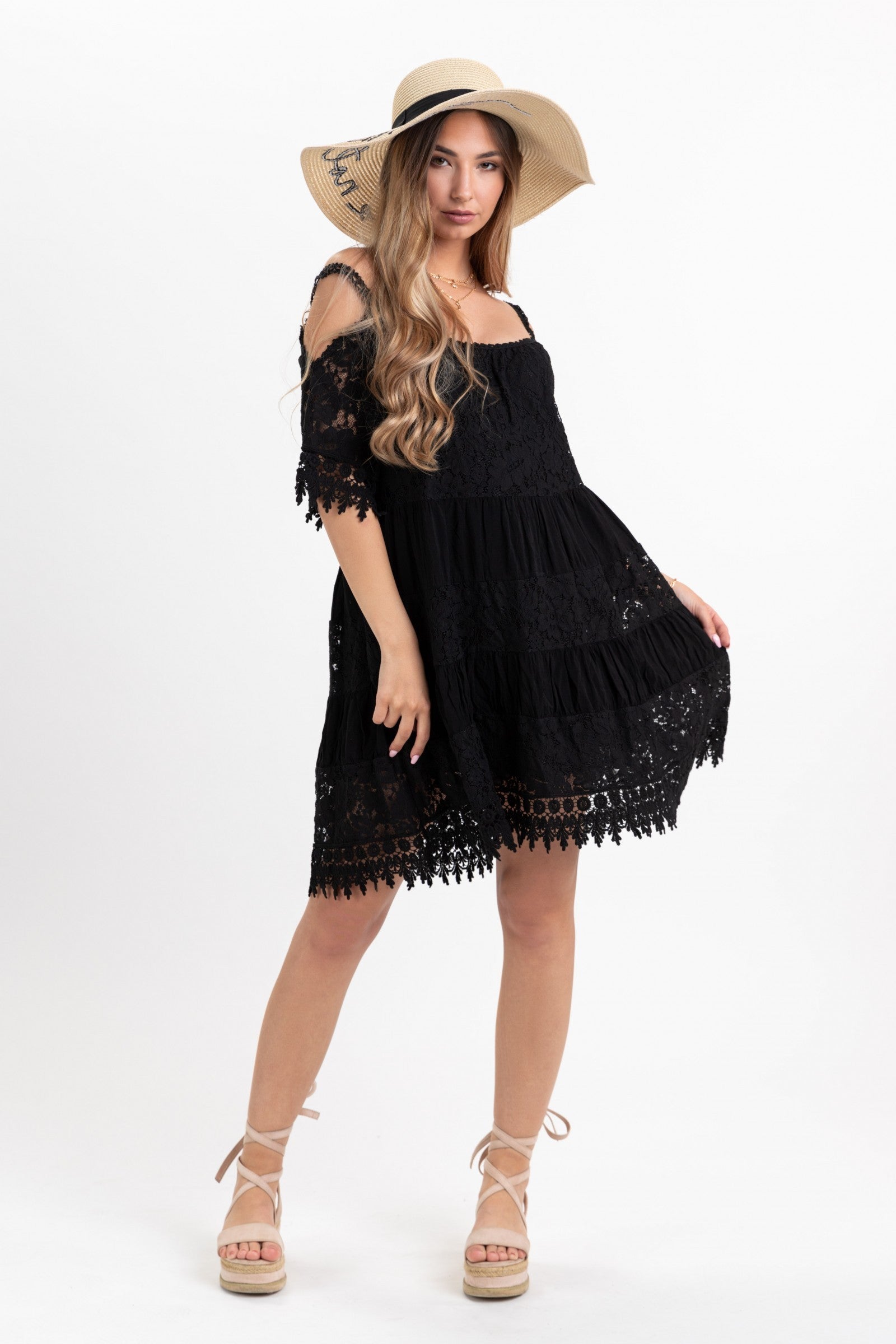 A sophisticated black lace dress featuring an open shoulder design, round collar, and beautiful edges, perfect for elegant occasions.