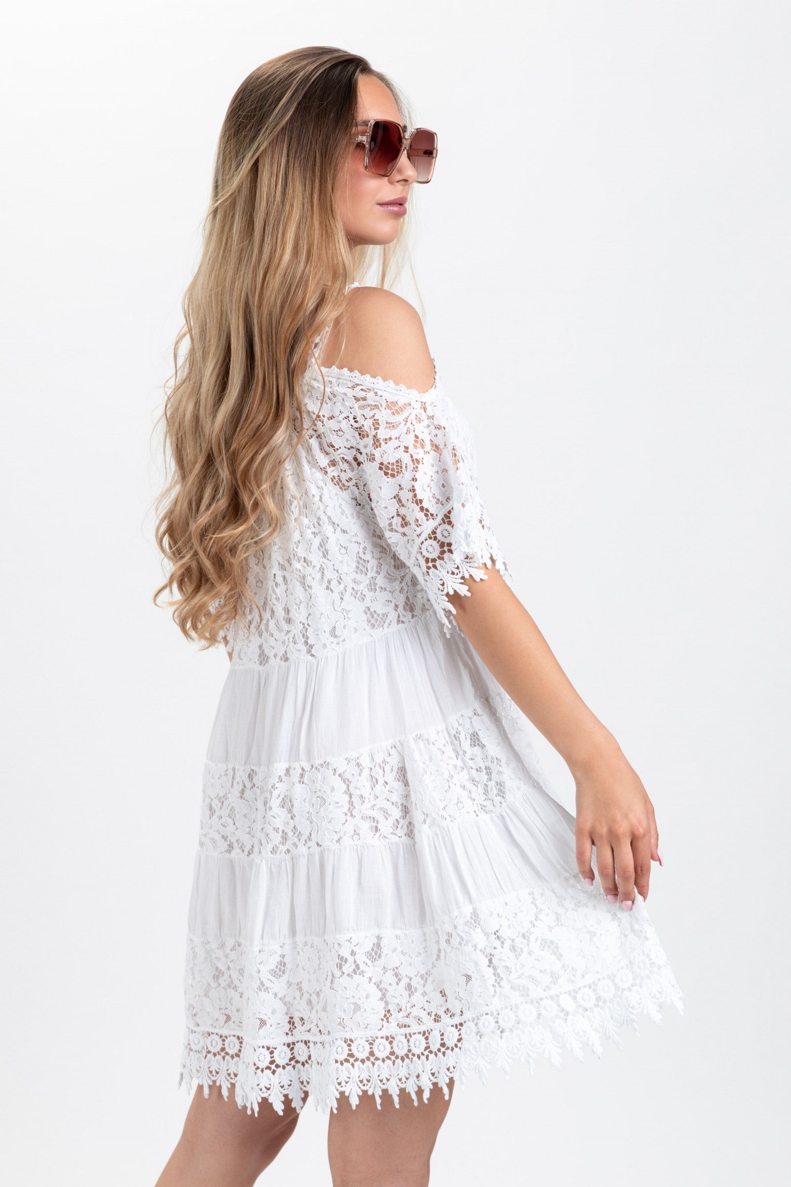 Elegant white lace dress with open shoulders and round collar, showcasing beautiful edges and mid-thigh length.