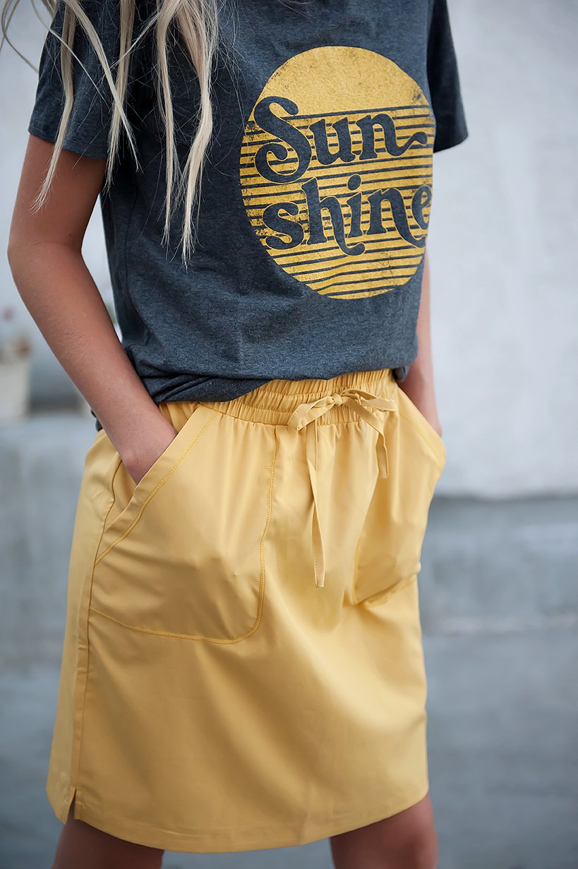 DT BREEZE Sporty Skirt in vibrant sunflower yellow, showcasing its soft and stretchy fabric, perfect for casual wear.