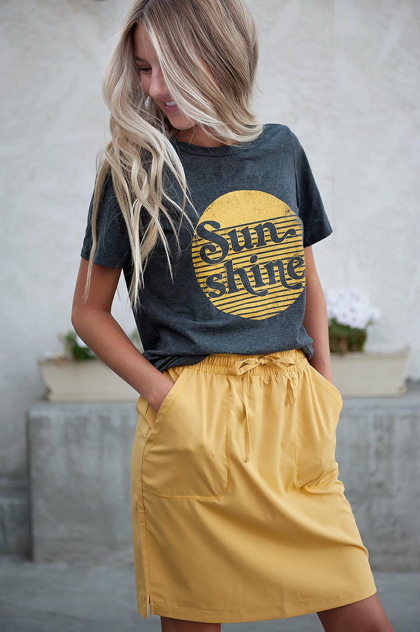 DT BREEZE Sporty Skirt in vibrant sunflower yellow, showcasing its soft and stretchy fabric, perfect for casual wear.