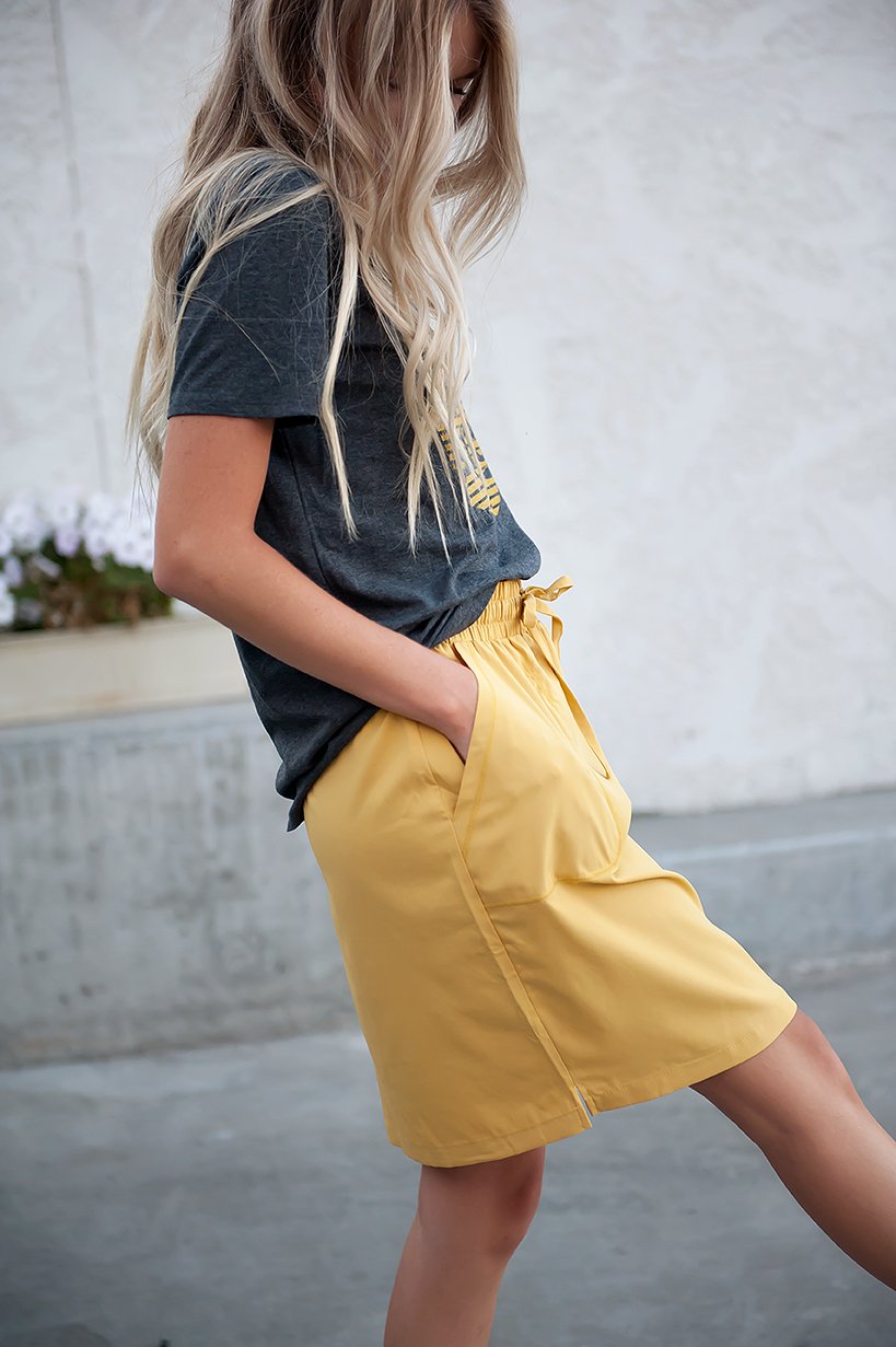 DT BREEZE Sporty Skirt in vibrant sunflower yellow, showcasing its soft and stretchy fabric, perfect for casual wear.