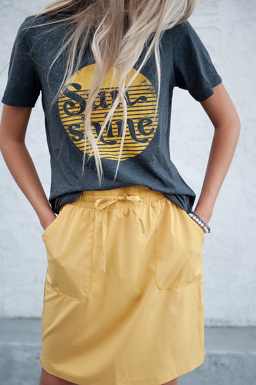 DT BREEZE Sporty Skirt in vibrant sunflower yellow, showcasing its soft and stretchy fabric, perfect for casual wear.