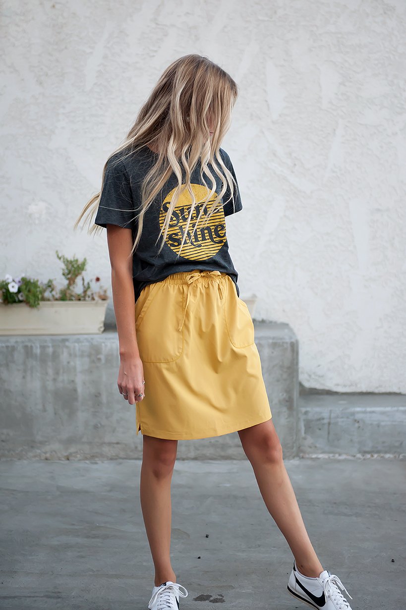 DT BREEZE Sporty Skirt in vibrant sunflower yellow, showcasing its soft and stretchy fabric, perfect for casual wear.