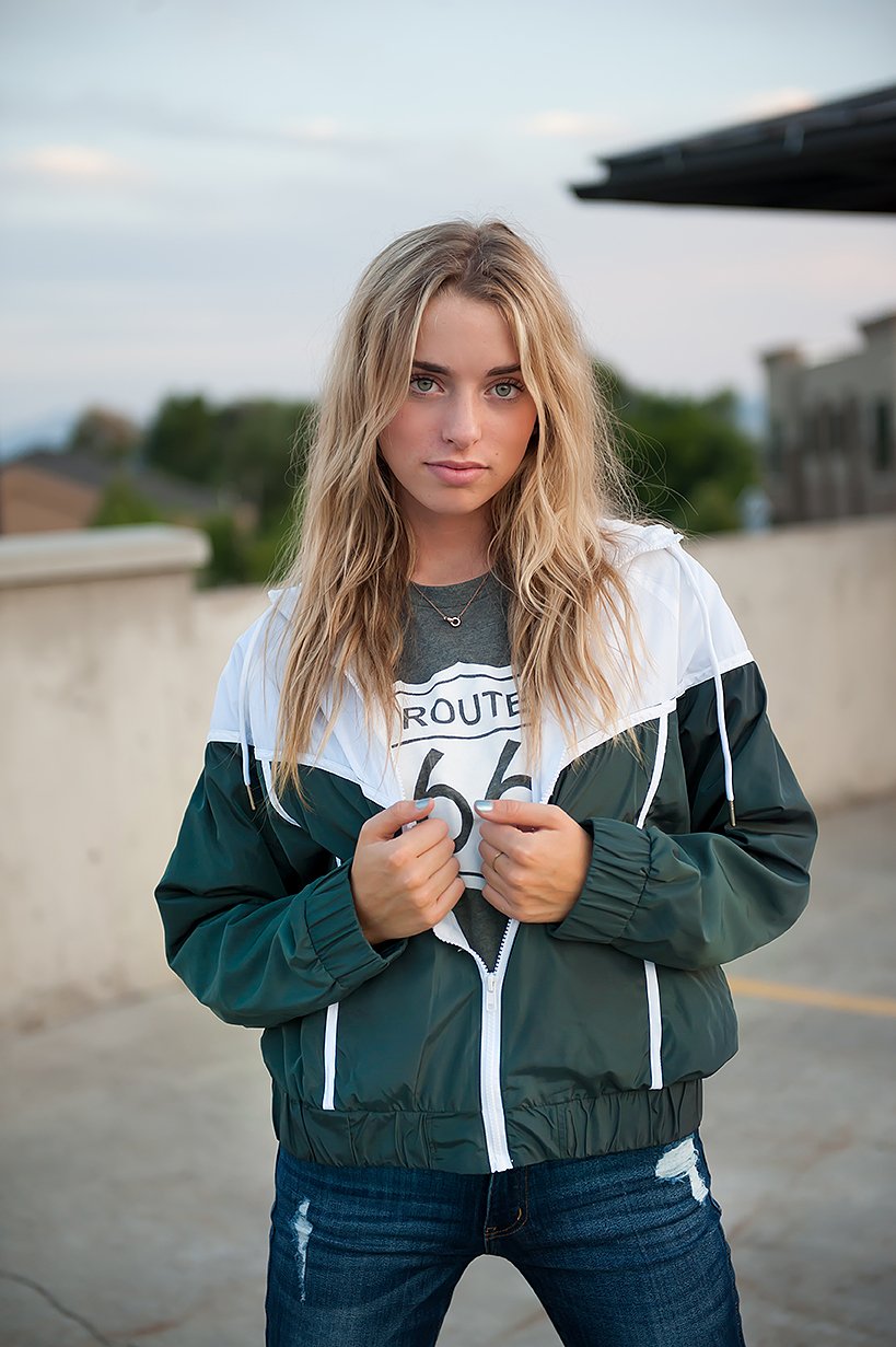 DT Green & White drawstring windbreaker jacket featuring a stylish retro design with white accents and zip closure pockets.