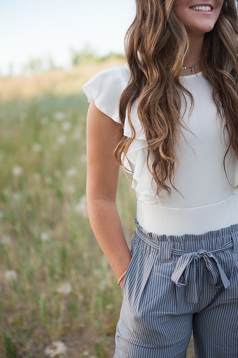 DT Izzy Belted Striped Palazzo Pants in grey and white, showcasing a stylish design with a belt and wide legs.