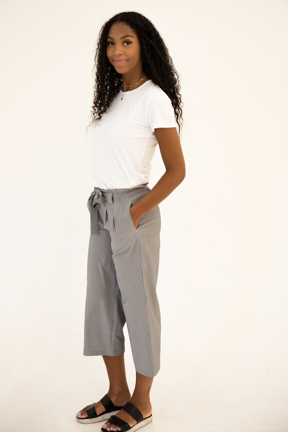 DT Izzy Belted Striped Palazzo Pants in grey and white, showcasing a stylish design with a belt and wide legs.