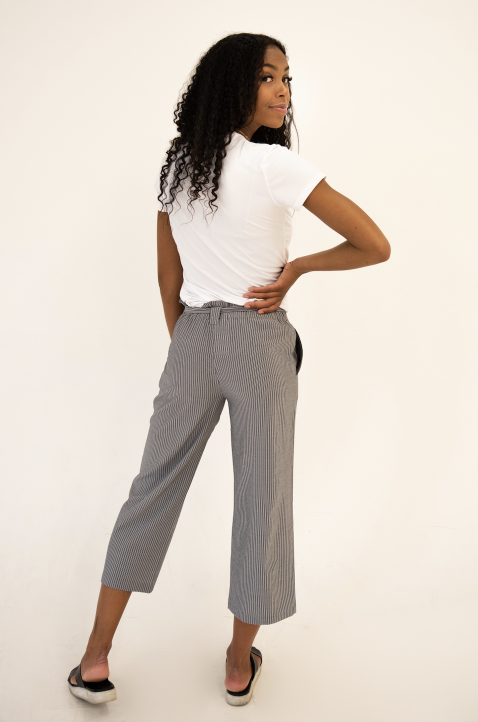 DT Izzy Belted Striped Palazzo Pants in grey and white, showcasing a stylish design with a belt and wide legs.