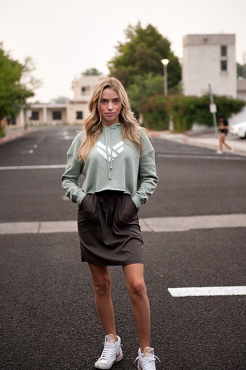 A lightweight sage green cropped hoodie featuring an adjustable hood and raw hem, perfect for casual wear.