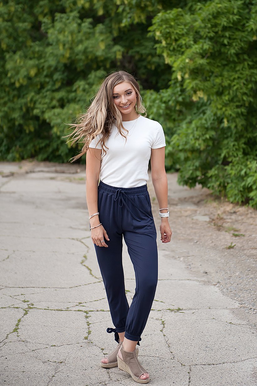 DT Shelby Tie-ankle pants in Navy featuring a feminine knot at the ankle, adjustable drawstring waistband, and functional pockets.