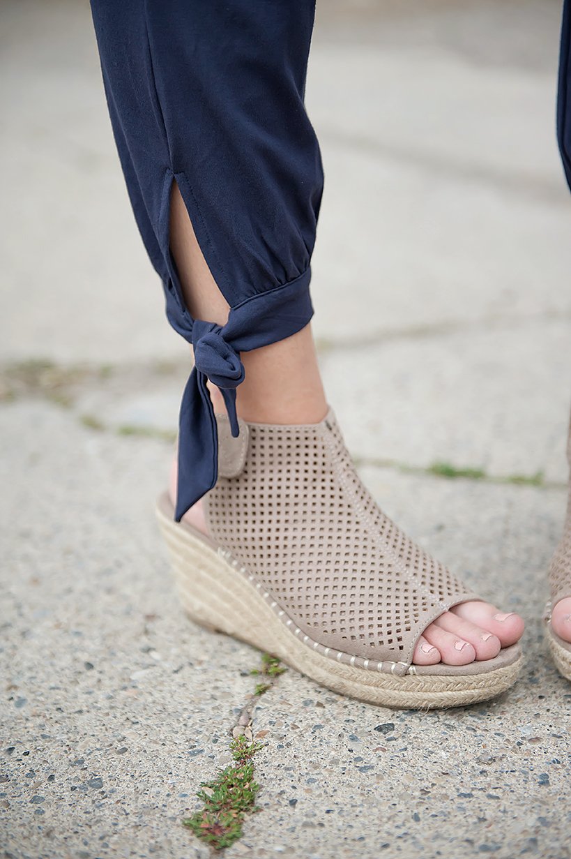 DT Shelby Tie-ankle pants in Navy featuring a feminine knot at the ankle, adjustable drawstring waistband, and functional pockets.