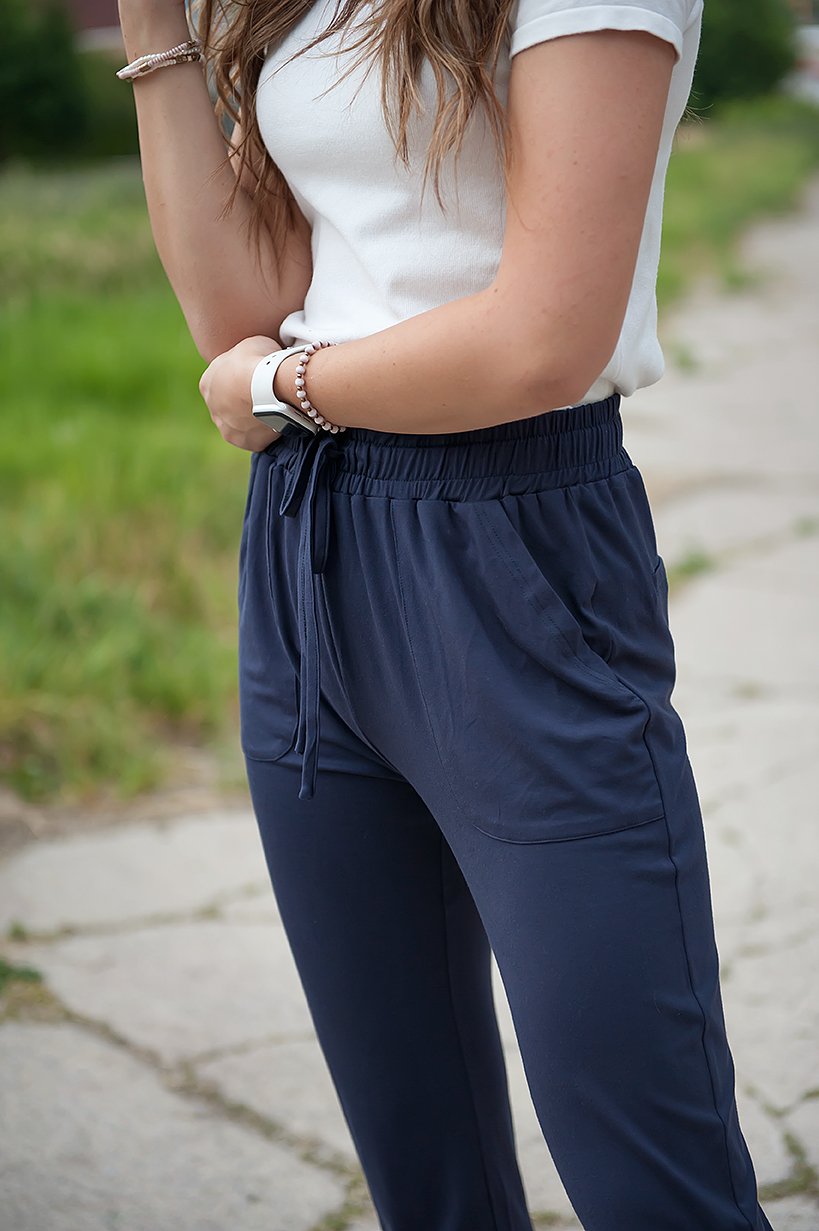 DT Shelby Tie-ankle pants in Navy featuring a feminine knot at the ankle, adjustable drawstring waistband, and functional pockets.